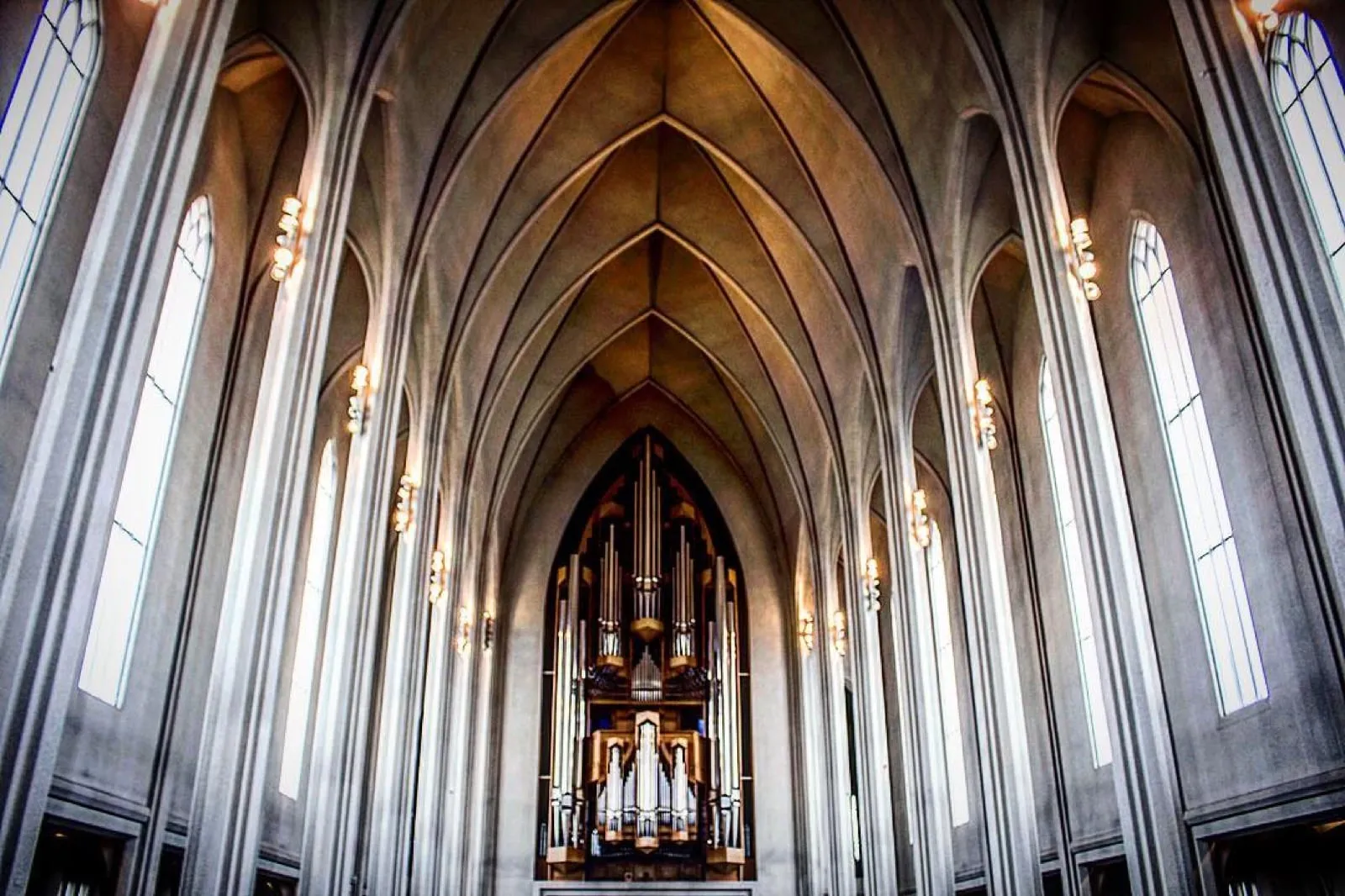 Inside Hallgrímskirkja, tall white arches leading to an enormous pipe organ