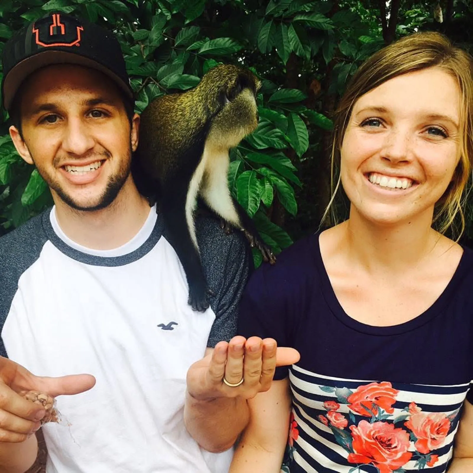 Michael and Chantelle holding out their hands with a monkey perched on Michael’s shoulder