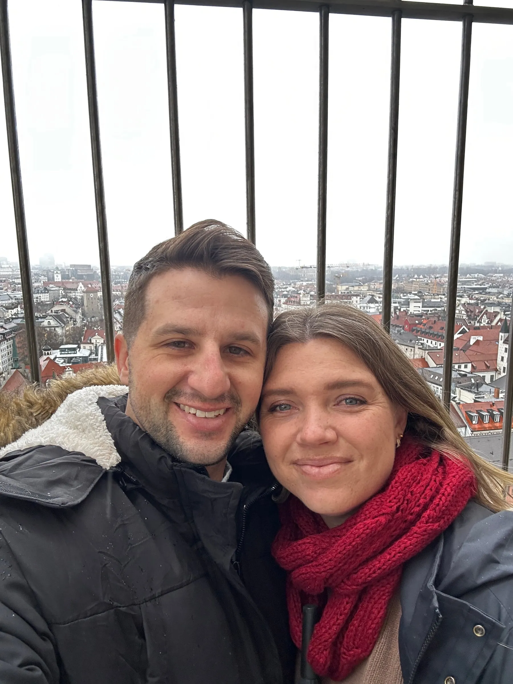 Michael and Chantelle taking a selfie at the top of the New Town Hall tower with Munich's rooftops behind them