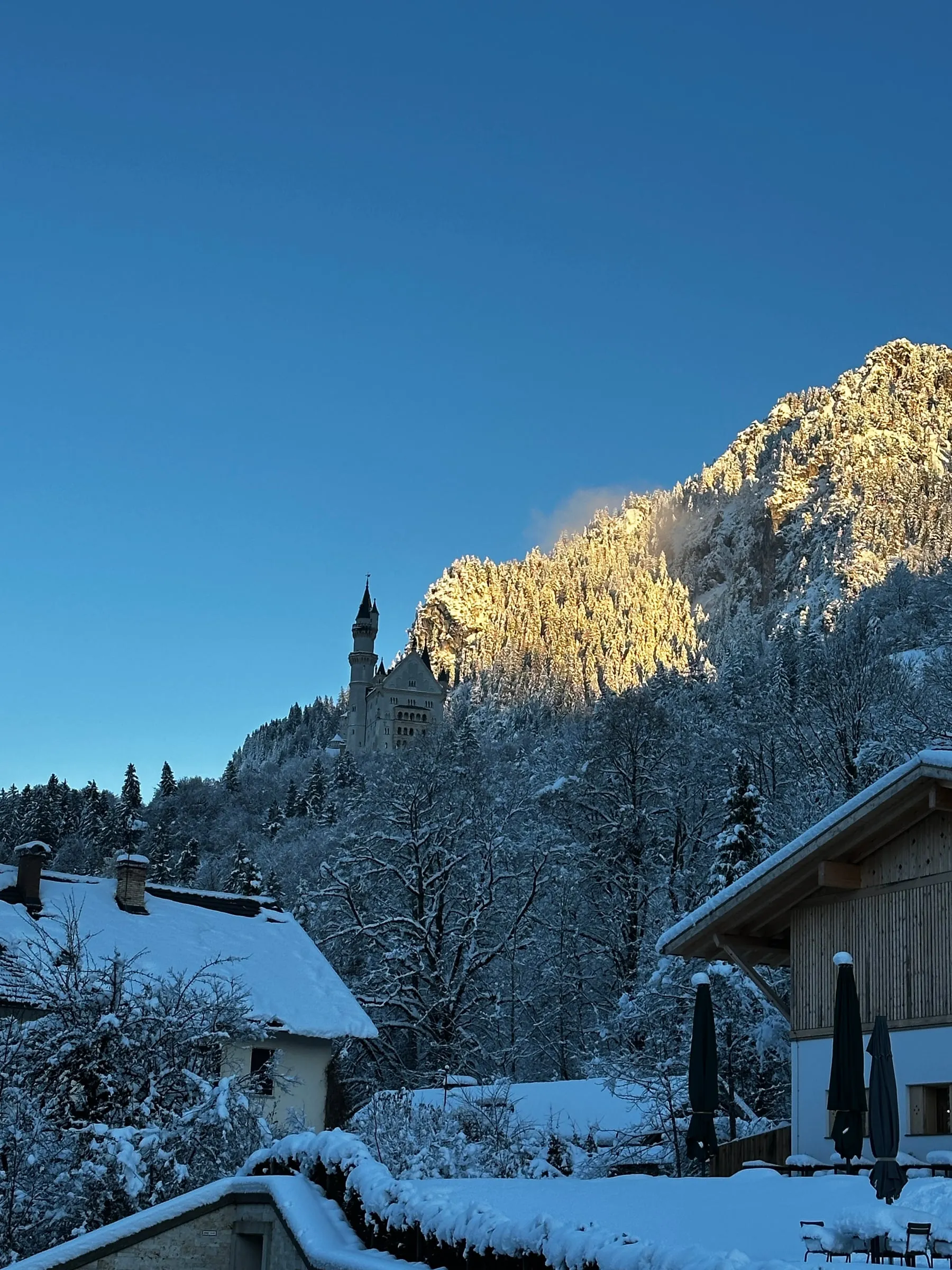 Late afternoon sun lighting up a snowy mountain peak near Schwangau