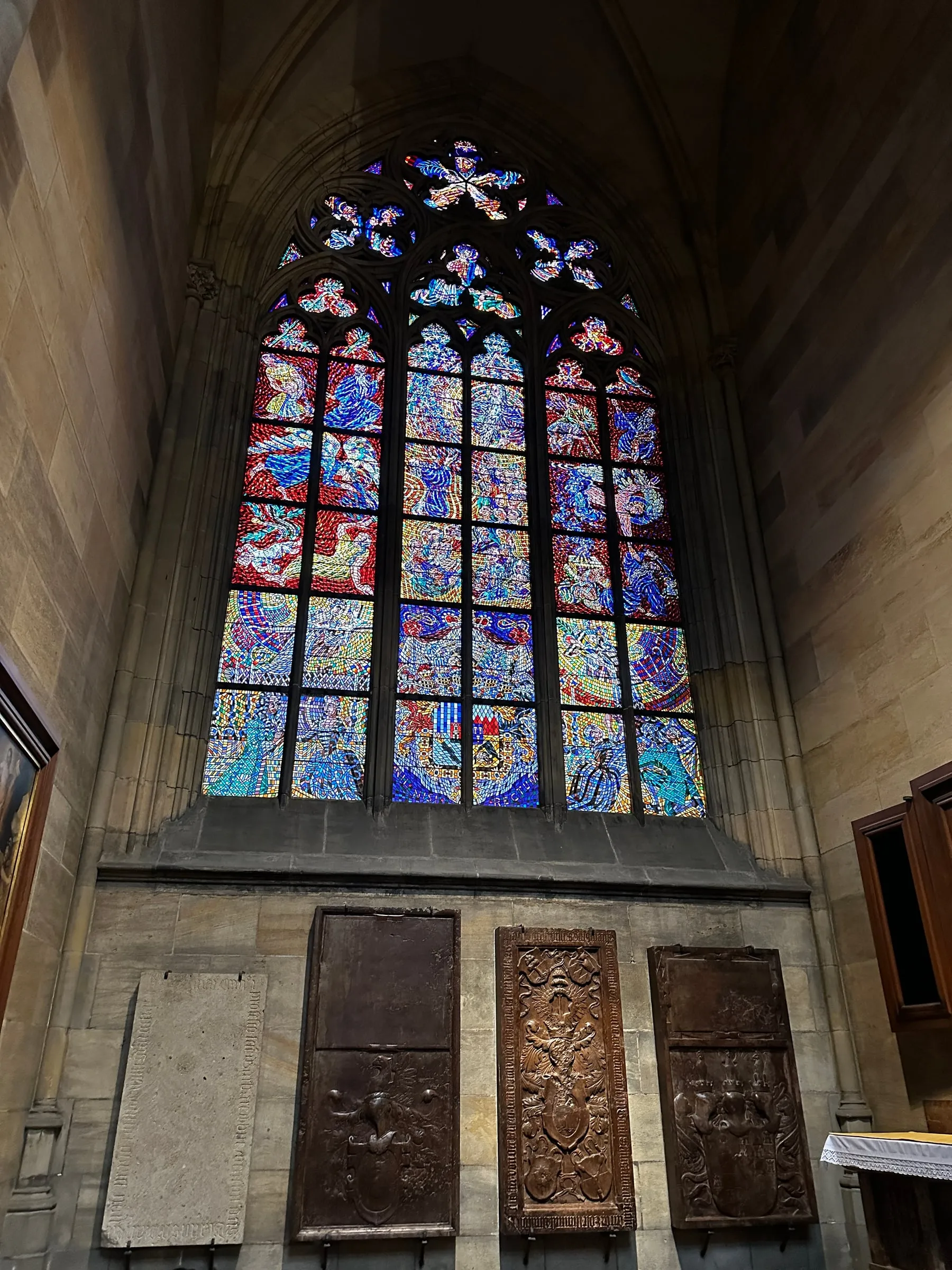 Colorful stained glass windows inside St. Vitus Cathedral in Prague