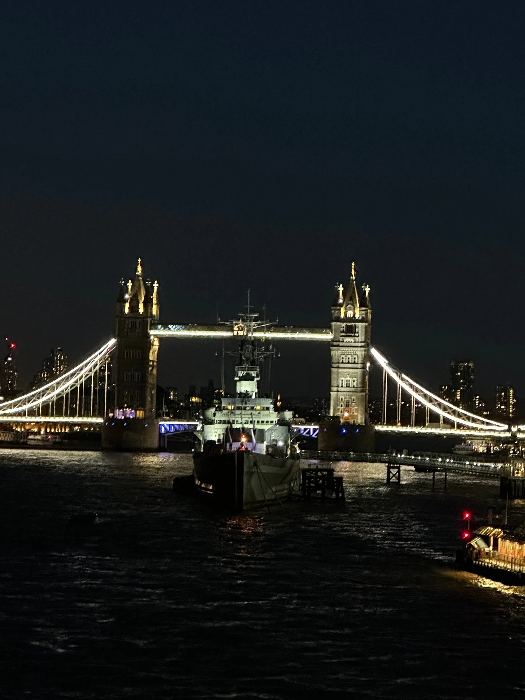 Tower Bridge lit up at night over the River Thames
